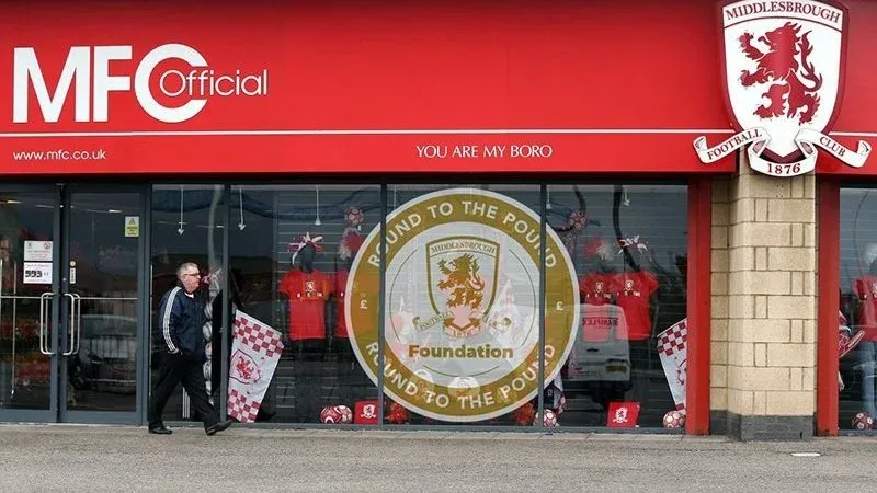 MFC Official storefront window with the Round to the Pound decal