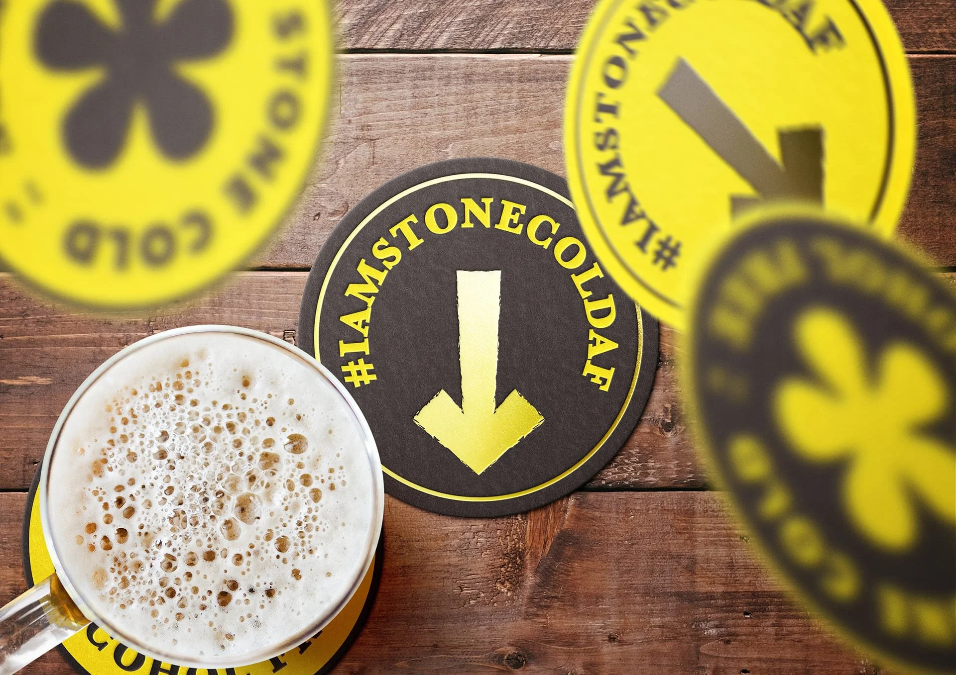 Stone Cold AF beer mats and a poured glass on a bar, IAmStoneColdAF