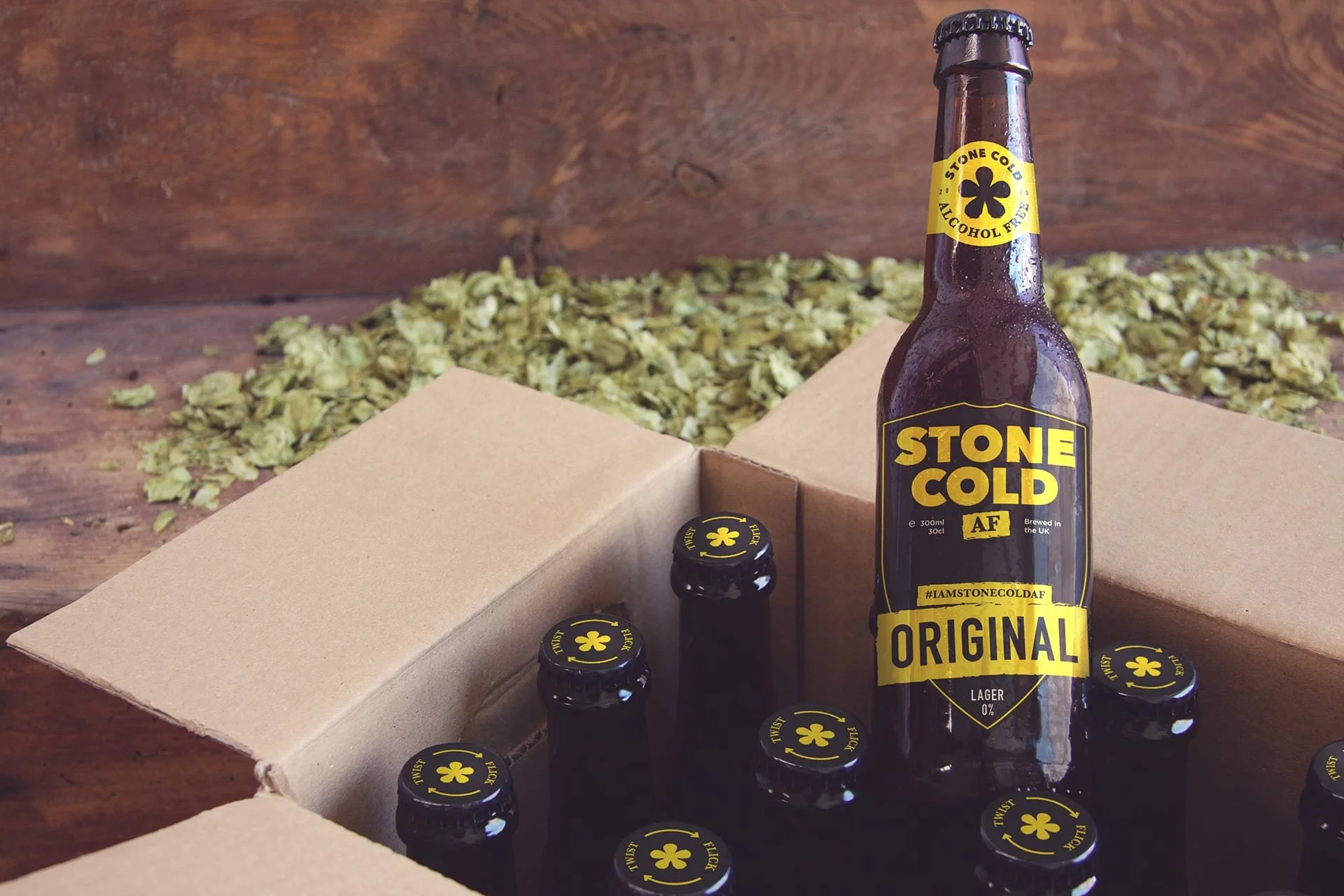 Stone Cold AF Original bottle standing in an open case of bottles