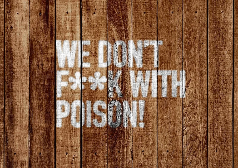 We don't f**k with poison stencilled onto wood planking